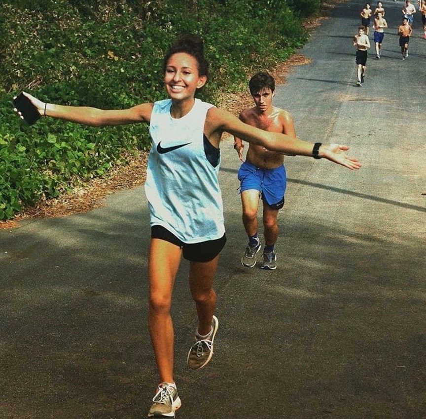 Girl Smiling while running with arms out